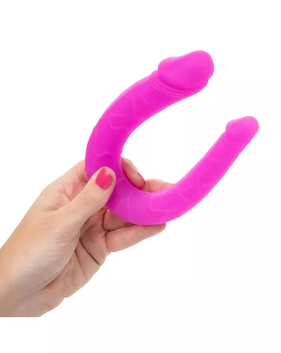 a female hand holding a Silicone Double Dong dildo